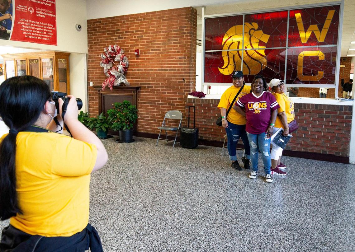 Shannon Rudiselll Richardson, left, Rhoda Murphy, center, and Deborah Rudisell get a photo taken in front of the stained glass art at West Charlotte High School in Charlotte, NC on Saturday, April 30, 2022. The school has built a new building for students and the historic West Charlotte high school building will be torn down.