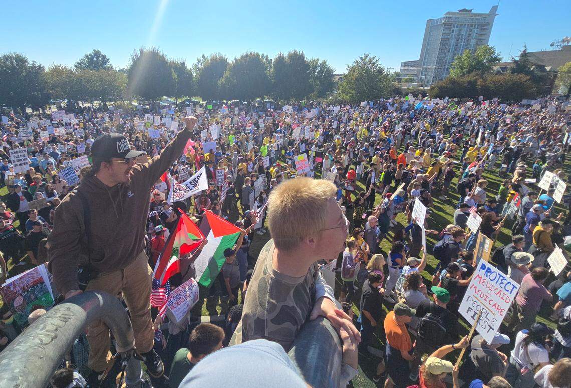 Protesters take part in the No Kings rally in First Ward Park on Saturday, Oct. 18. Hundreds showed up to protest against President Donald Trump.