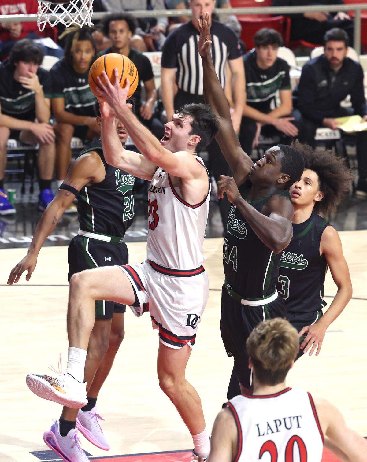 Davidson Wildcats guard Connor Kochera, center, drives down the lane for a layup as William Peace forward/center Chuks Ezeonu, right, trails behind during action on Monday, November 4, 2024.