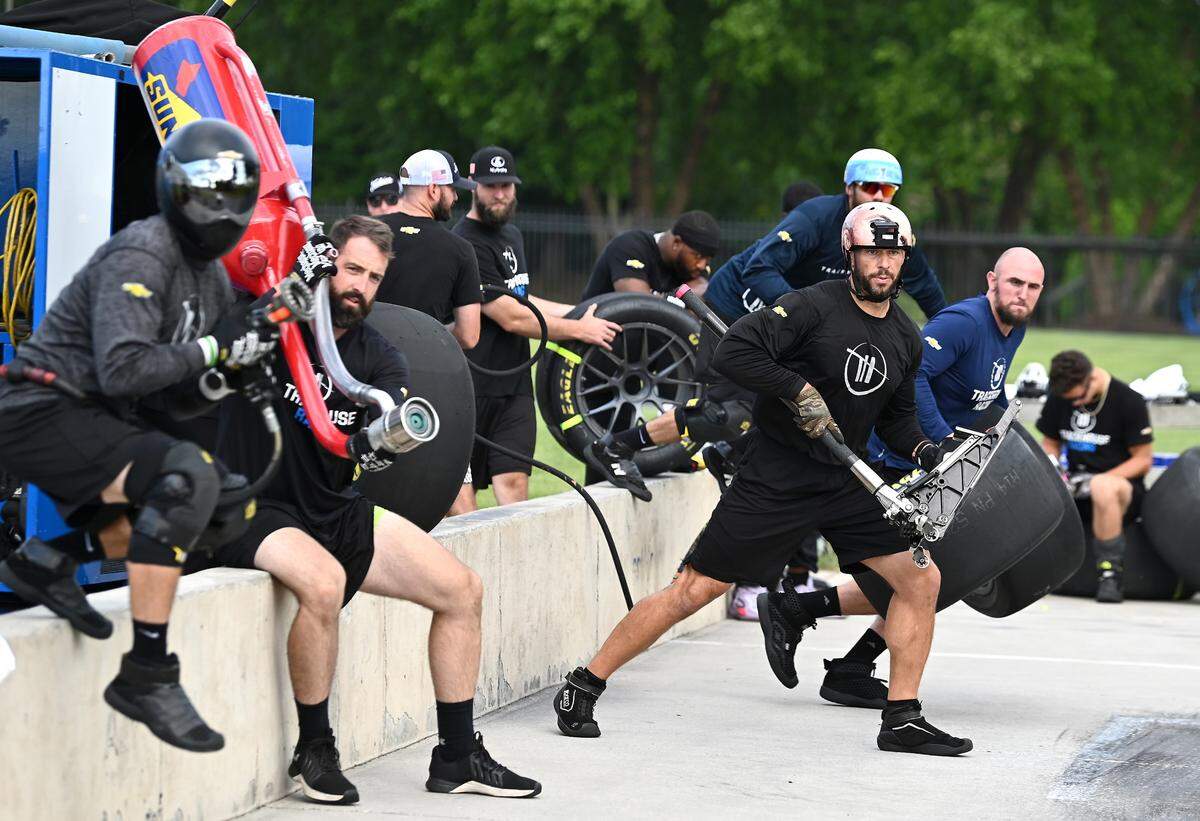 NASCAR driver Ross Chastain’s Trackhouse Racing pit crew members (L-R) Ken Pozega, Brook Davenport, Shane Wilson, Matt Simmons, and Michael Roberts prepare to rush around the car during pit practice on Tuesday, June 11, 2024.