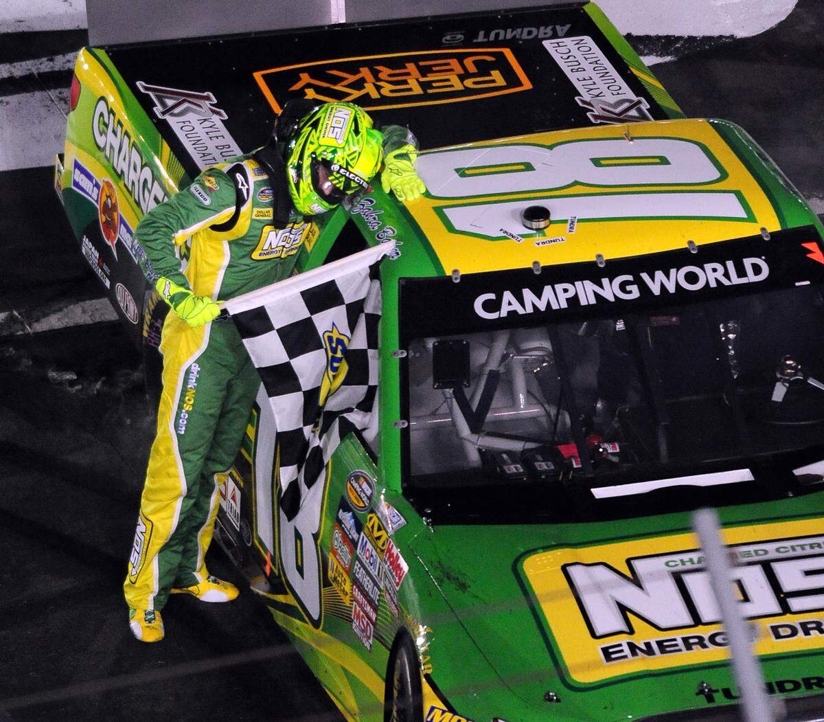 5/20/11 NASCAR Camping World Truck Series driver (18) Kyle Busch leans his head against the roof of his truck after winning the 9th Annual North Carolina Education Lottery 200 at Charlotte Motor Speedway Friday. Jeff Siner - jsiner@charlotteobserver.com