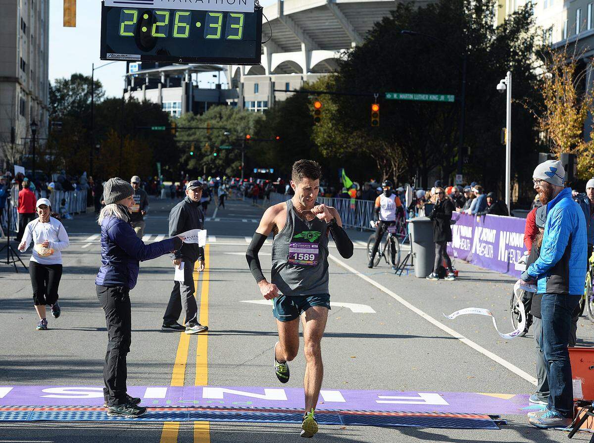 Charlotte Marathon winner Bert Rodriguez crosses the finish line at Saturday morning’s annual Novant Health Charlotte Marathon uptown. The event features five different races: the marathon, half-marathon, marathon relay, 5K, and kid’s 1-mile run. It began in 2005 as the Thunder Road Marathon but the name was changed to the Novant Health Charlotte Marathon in January of 2016. The marathon, 1/2 marathon and relay began at 7:30am. The 5K started at 7:45am. The kid’s 1 mile & marathon program started at 7:50am. Since 2013, the Novant Health Charlotte Marathon has donated $89,000 to Novant Health Hemby Children’s Hospital Child Life Program. The donation helps support patient programming items and supplies to help make the hospital feel a little more like home to the children staying there - with everything from arts and crafts to video games and movies, wagons and ride-on toys. Each year, the Novant Health Charlotte Marathon also supports 35-40 different Boy Scout troops, high school organizations and non-profit organizations by donating over $21,000 to them through the volunteer program, cheer station contest and ambassador program. The Novant Health Charlotte Marathon is an annual race that takes place in Charlotte, NC every November. The event features five different races: the marathon, half-marathon, marathon relay, 5K, and kid’s 1-mile run. Runners experience the sights and sounds of the Southeast’s fastest growing city, including the Queen City’s signature tree lined streets, historic landmarks, major sporting venues and the most eclectic neighborhood parties. The race finishes in the heart of Uptown Charlotte at Romare Bearden Park. With entertainment along the course, major headliners at the finish line festival, and five distance options, it’s a race for all runners