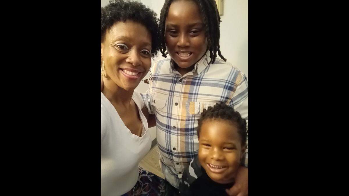 Pamela Curry with her sons, 9-year-old Elisha and Elian, 5. The Charlotte mom and former CMS bus driver is grateful that her boys will get Christmas presents thanks to the Salvation Army’s Angel Tree program. Observer readers support that program through donations to the Empty Stocking Fund.