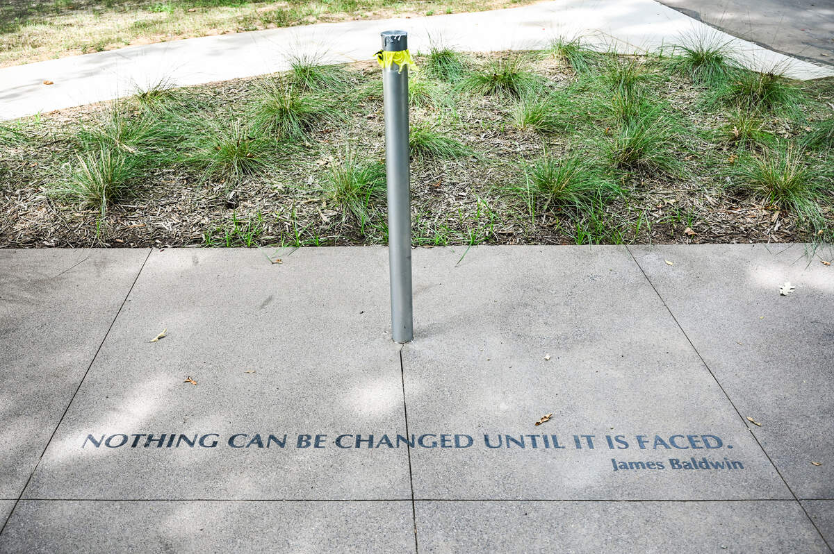 Only a pole stands where a historical marker was removed after being vandalized at Reedy Creek Park in Charlotte. The marker recognized the 1929 lynching of Willie McDaniel, whose death was one of three confirmed instances of racial terror violence against Black Americans in Mecklenburg County. Researchers today say modern day lynchings happen, and they largely go uninvestigated.