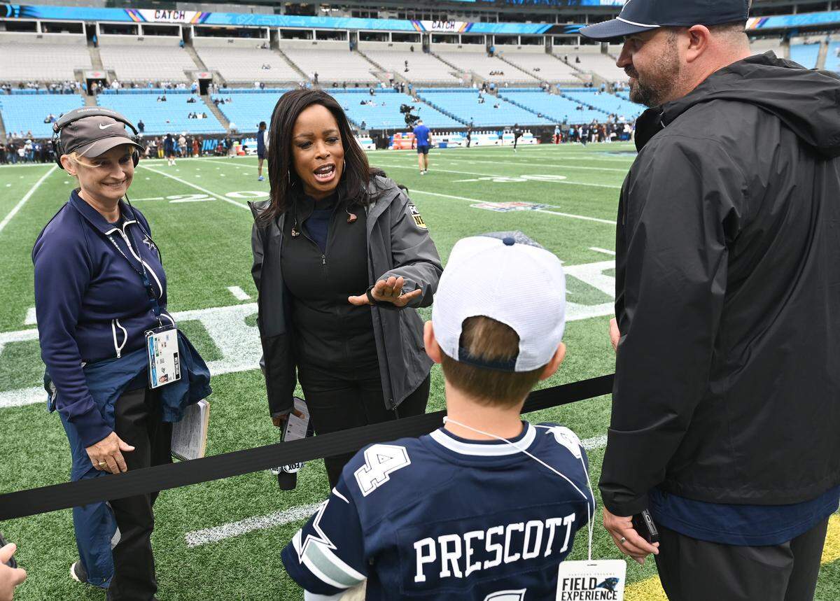 FOX Sports sideline reporter Pam Oliver, center, speaks with fans along the Bank of America field prior to the Carolina Panthers vs Dallas Cowboys game on Sunday, October 12, 2025. Oliver is the longest tenured NFL sideline reporter with more than 500 games.