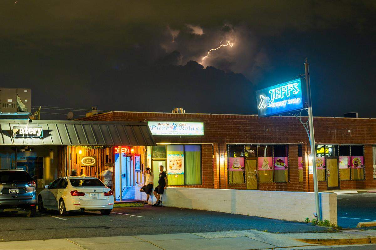 Customers hang around outside Jeff’s Bucket Shop on Montford Drive.