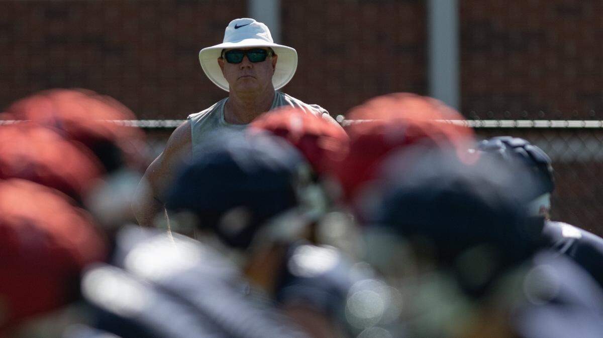 Providence Day School Chargers head football coach Chad Grier watches his team run plays in morning practice on Tuesday, Aug. 2, 2022 at Providence Day School in Charlotte, N.C.