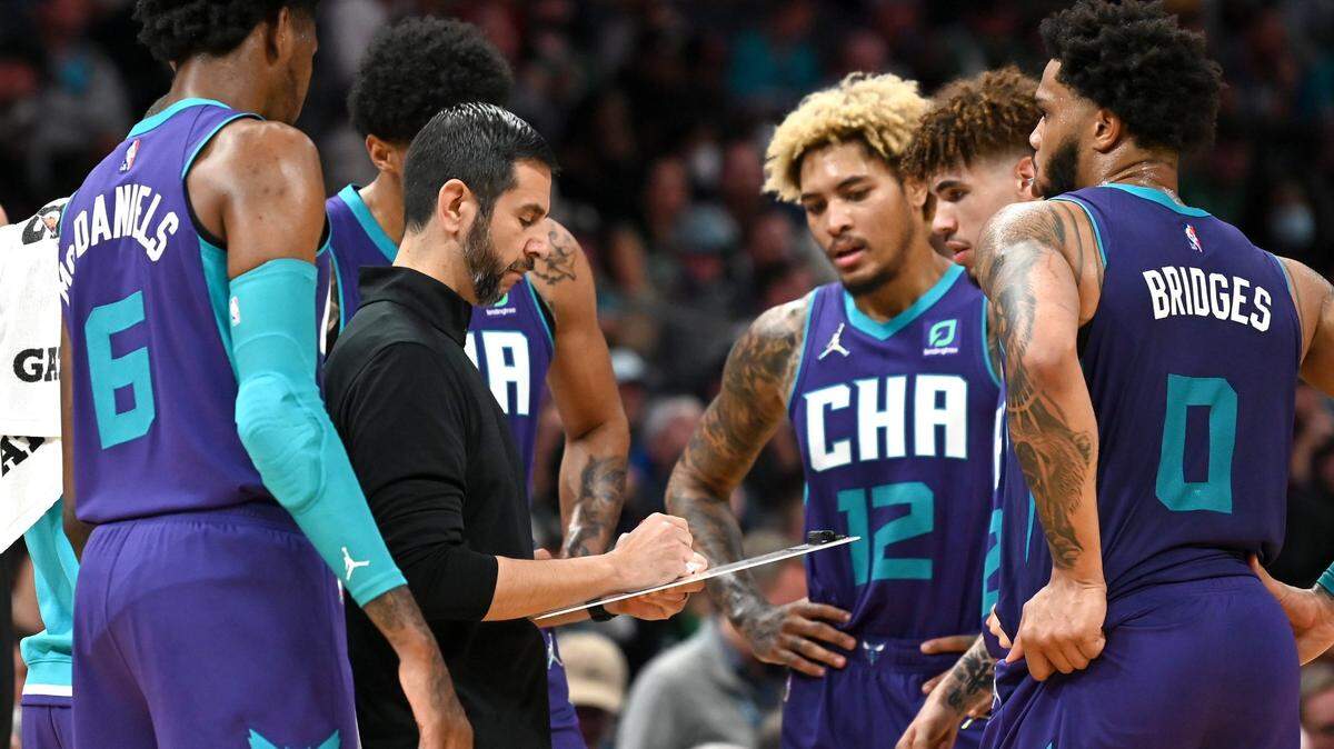 Charlotte Hornets players gather around head coach James Borrego, center, during a timeout in the action against the Boston Celtics at Spectrum Center in Charlotte, NC on Monday, October 25, 2021. The Celtics defeated the Hornets 140-129 in overtime.