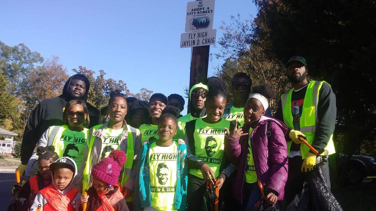 Family and friends of Jaylin Craig posed for photos before collecting litter on LaSalle and nearby streets in north Charlotte Saturday afternoon to honor his legacy of giving.