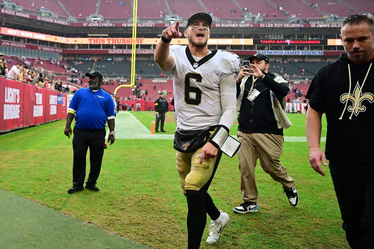 New Orleans quarterback Tyler Shough triumphantly leaves the field in Tampa Bay Sunday after his team upset the Tampa Bay Buccaneers, 24-20. The win did Carolina a favor in the NFC South race.