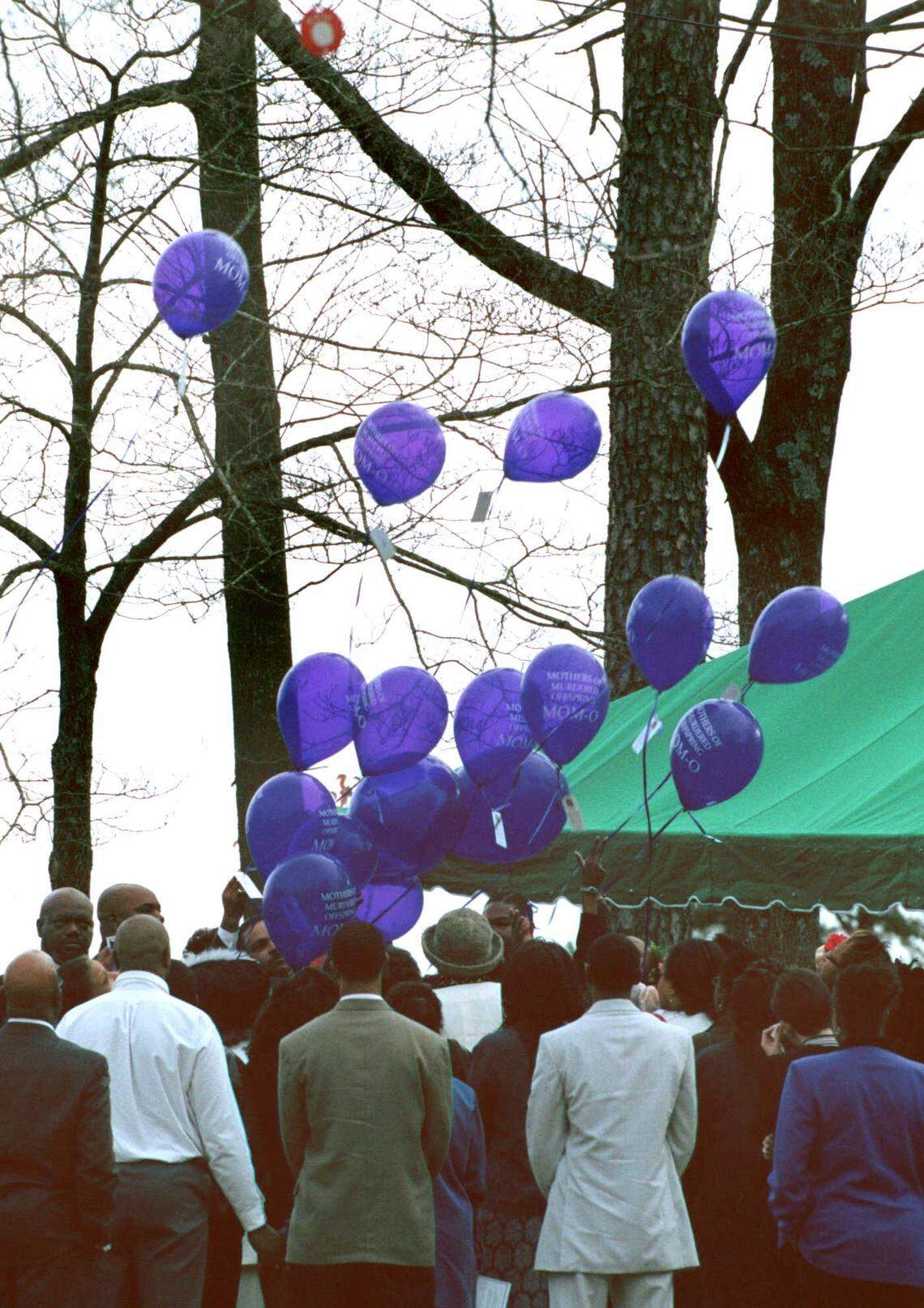 Mourners release 24 purple balloons, one for each year of Cherica Adams’ life, during her graveside service at Sunset Memory Gardens on Dec. 18, 1999.