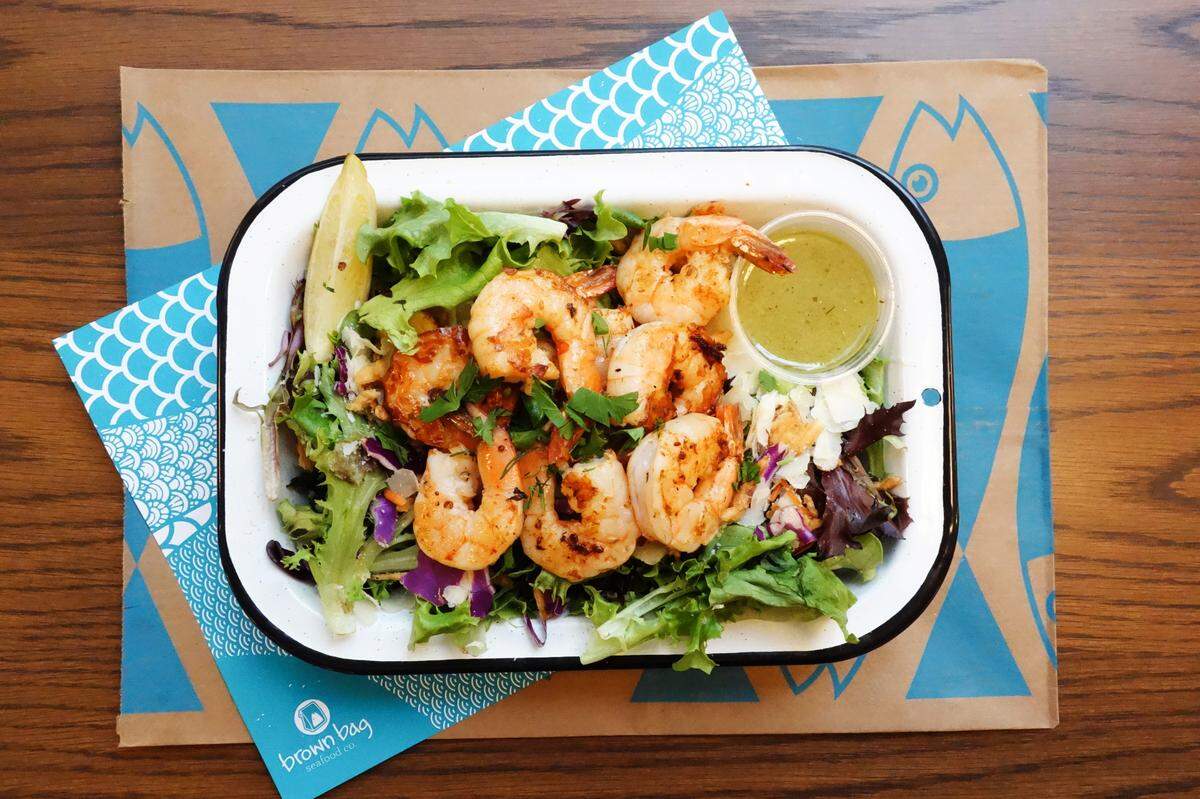 Brown Bag Seafood Co.’s menu includes grilled shrimp that can be served as a salad, sandwich, taco or “powerbox,” which is a mix of quinoa, wheatberry, brown rice, spinach and herbs.