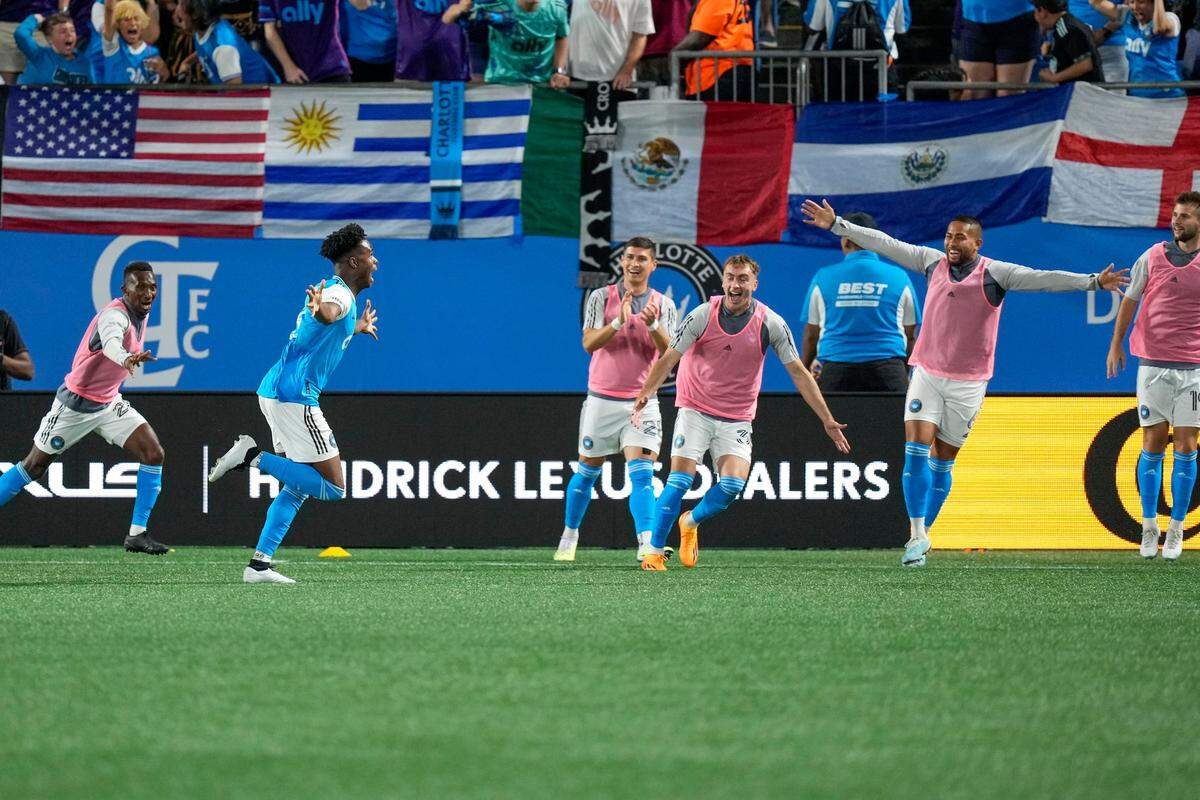 harlotte FC midfielder Brandon Cambridge (36) celebrates with teammates after his tying goal against the Chicago Fire during the second half at Bank of America Stadium.