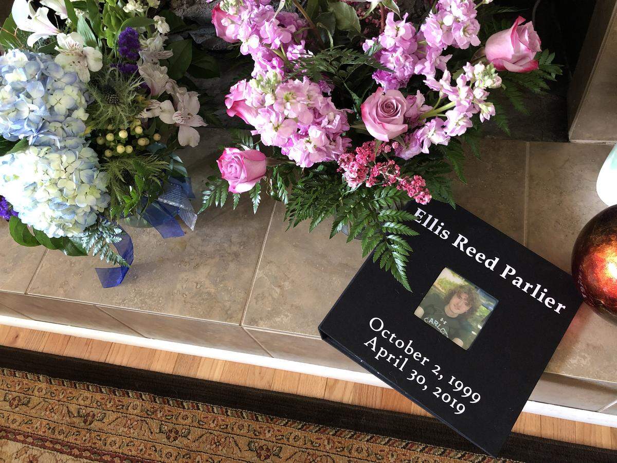 Floral arrangements and a book filled with handwritten memories collected at the memorial service for Reed Parlier in Mint Hill this past Sunday.