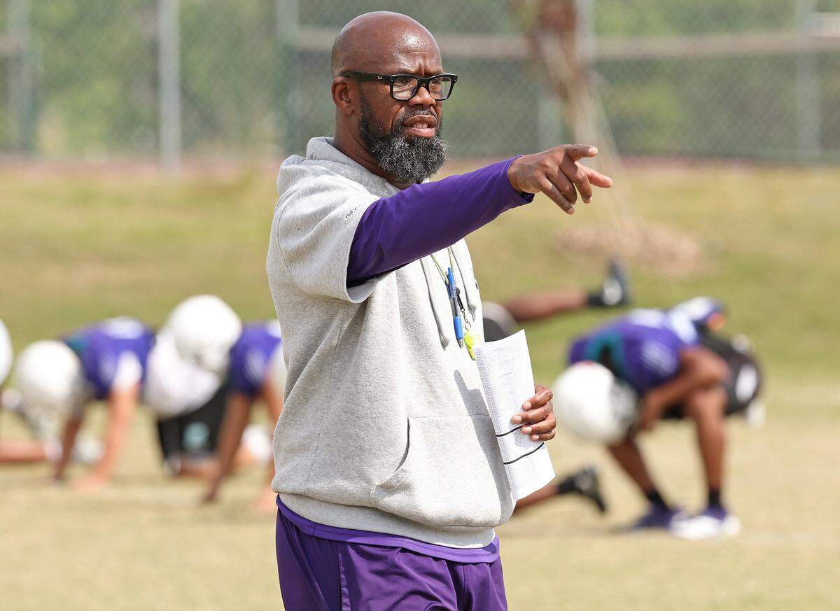 Palisades Pumas head football coach Jonathan Simmons speaks to players during a spring workout on Thursday, April 30, 2026. Palisades is going for its third straight winning season and wants to jump into the upper echelon of Charlotte teams.