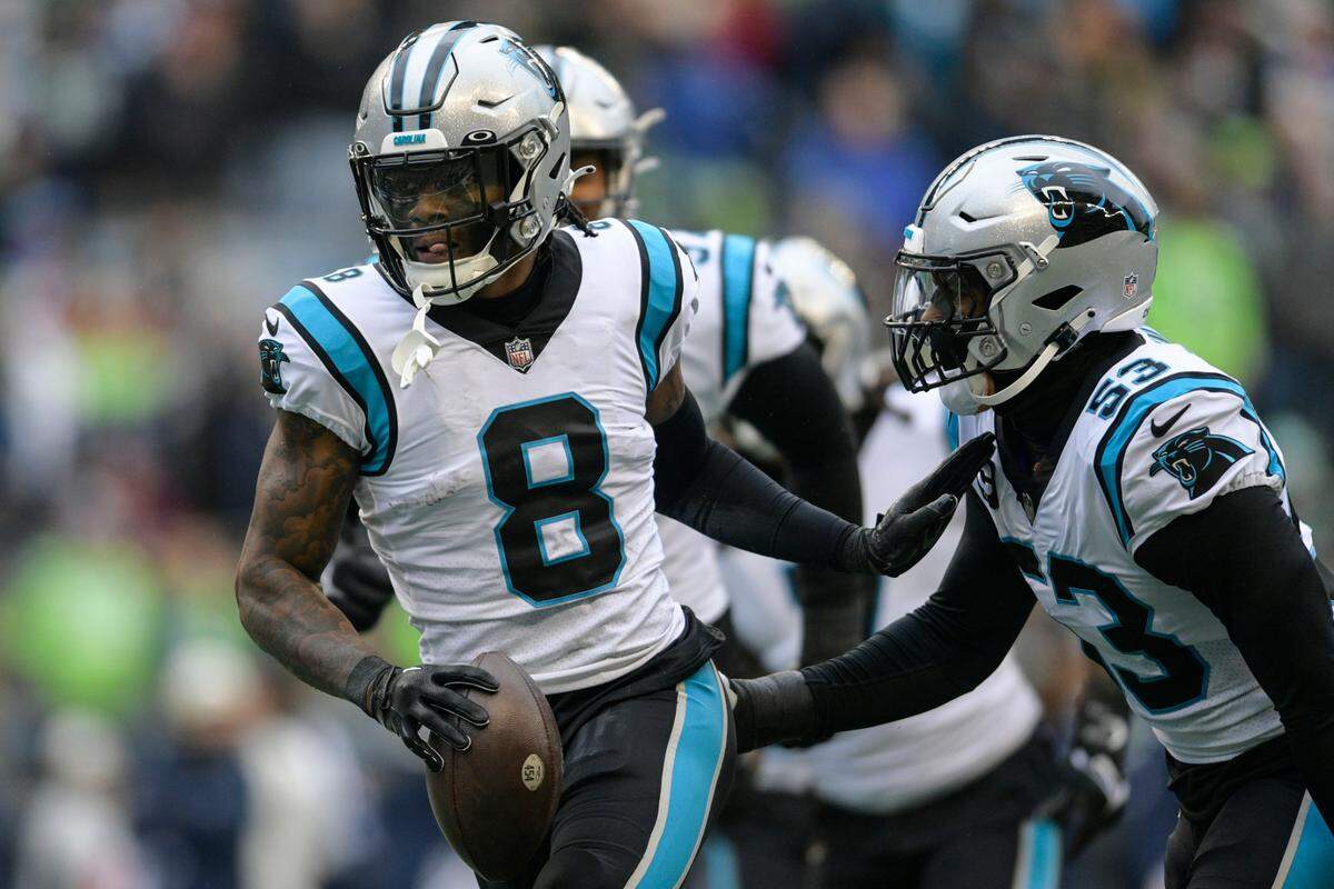 Carolina Panthers cornerback Jaycee Horn (8) celebrates his touchdown against the Seattle Seahawks during the first half of an NFL football game, Sunday, Dec. 11, 2022, in Seattle. (AP Photo/Caean Couto)