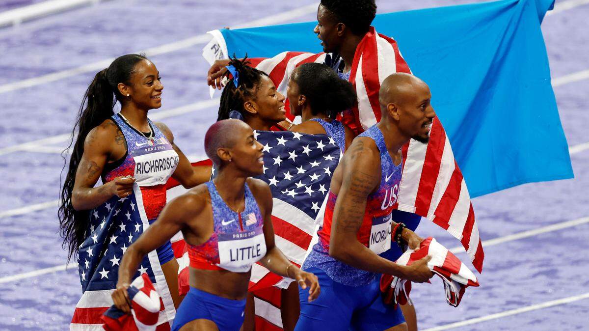Aug 3, 2024; Paris Saint-Denis, France; Kaylyn Brown (USA) congratulates Sha’carri Richardson (USA) and Melissa Jefferson (USA) after the womens 100m final during the Paris 2024 Olympic Summer Games at Stade de France. Mandatory Credit: Yukihito Taguchi-USA TODAY Sports
