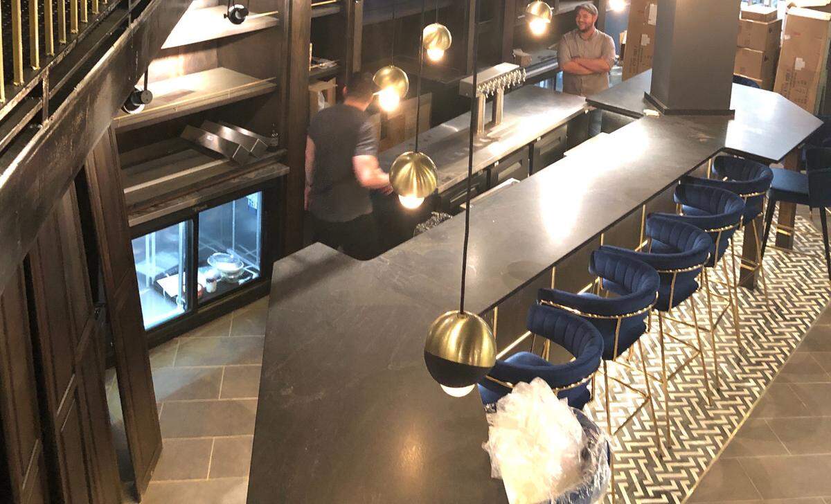 Brass fixtures and dark materials are meant to evoke a “grand” vibe at MOA.
