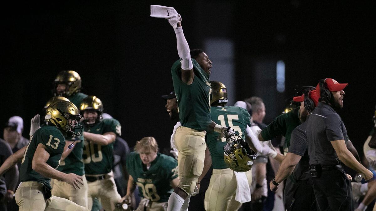 Cardinal Gibbons’ Will Mason (1) and his teammates react after recovering an onside kick in the fourth quarter as they try to mount a comeback against Julius Chambers on Friday, August 29, 2021 in Raleigh, N.C