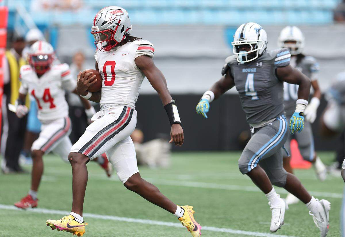 South Pointe Stallions quarterback J’Zavien Currence runs into the end zone for a touchdown during action against the Hough Huskies during Friday’s Keep Pounding Classic at Bank of America Stadium in Charlotte. 
