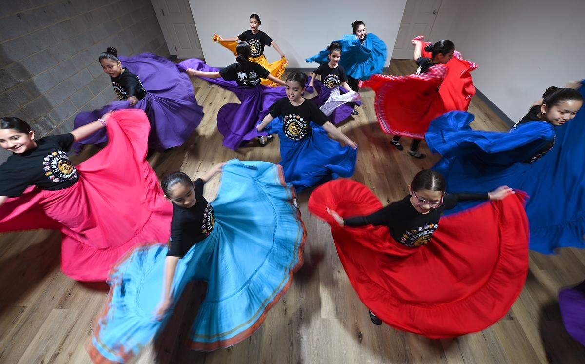 El Alma de la Luna dance members twirl during a recent rehearsal in Charlotte.