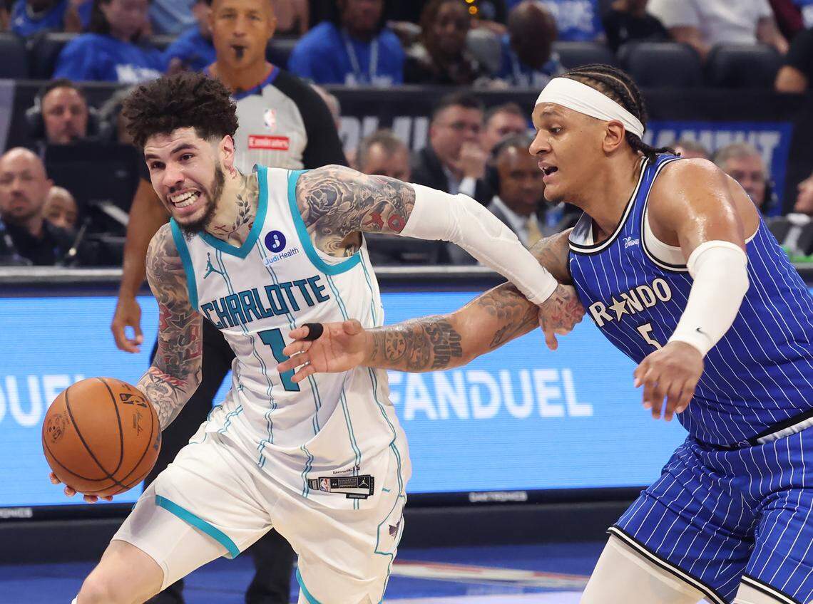 Charlotte Hornets guard LaMelo Ball, left, drives to the basket against Orlando Magic forward Paolo Banchero, right, during action at Kia Center in Orlando, FL on Friday, April 17, 2026. The Magic defeated the Hornets 121-90.
