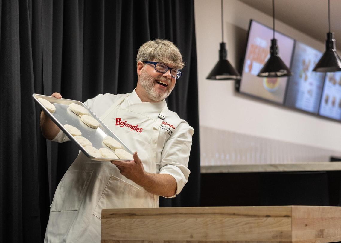 cholds up biscuits from the biscuit-cutting ceremony Tuesday, June 24, 2025, during the grand opening of the Bojangles Support Center in Charlotte.