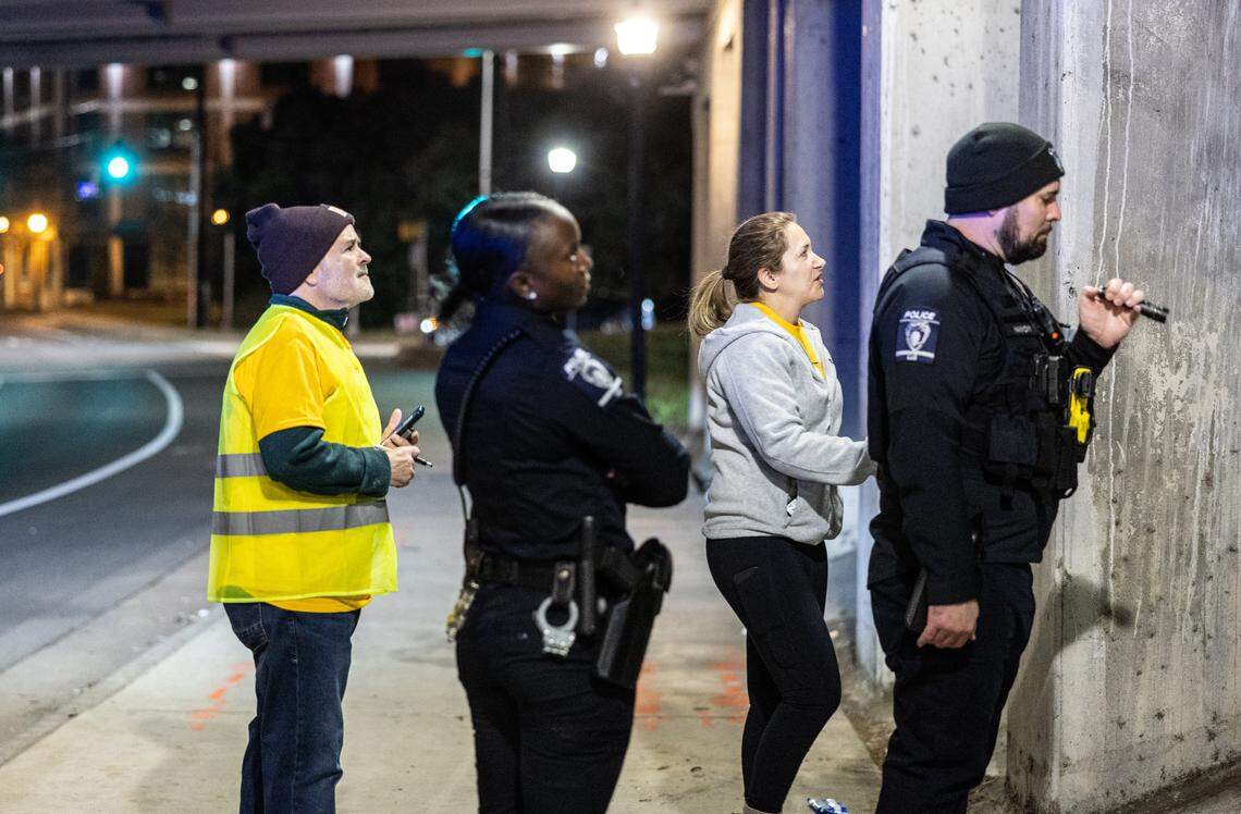 Volunteers and police officers check an underpass for unhoused people during the 2026 Point-in-Time Count in Charlotte, N.C., on Thursday, January 22, 2026.