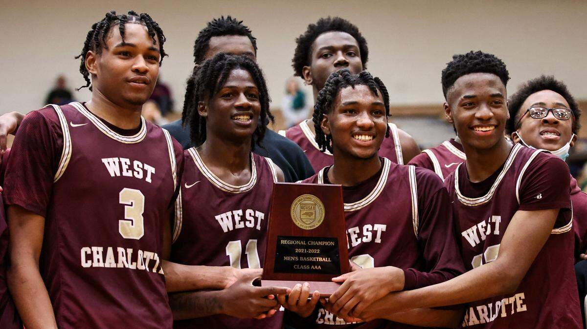West Charlotte High players celebrate their trophy after defeating Central Cabarrus on Saturday, March 5, 2022.
