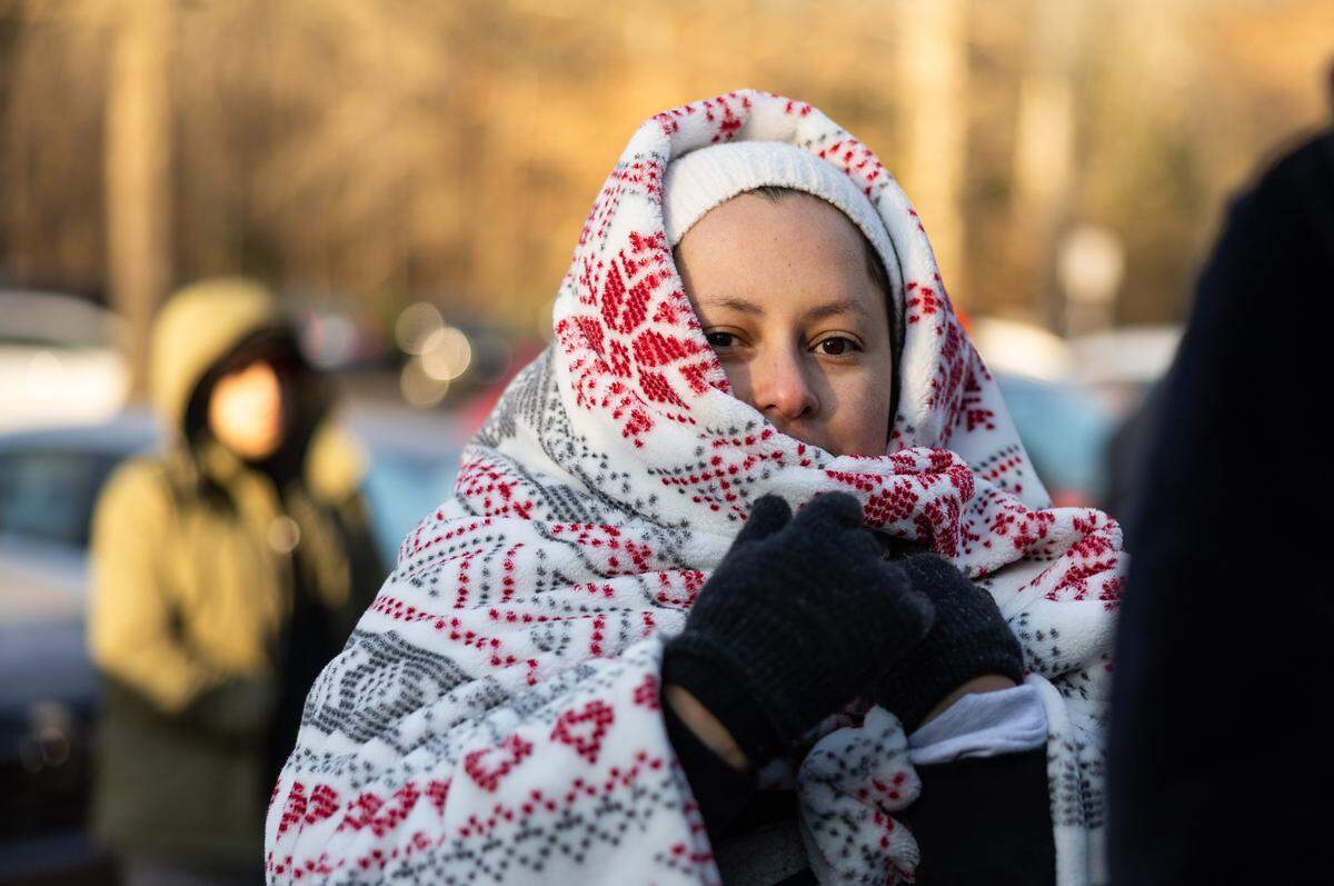 People wait outside of the Department Homeland Security office in Charlotte, N.C., on Wednesday, January 21, 2026.