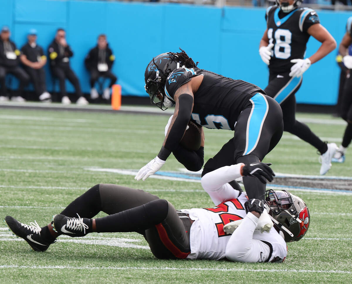 Carolina’s Sam Martin is tackled by Tampa Bays’s Lavonte David on Sunday at Bank of America Stadium in Charlotte.