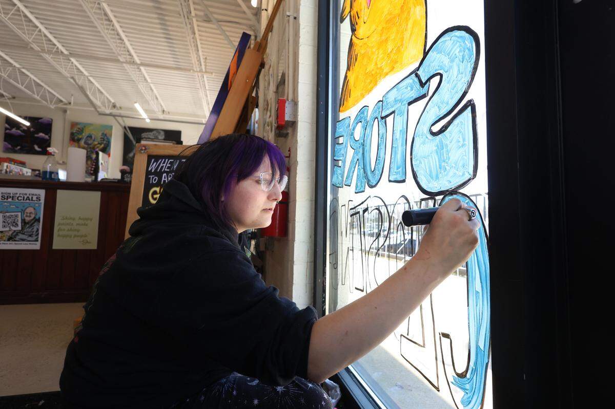 Cheap Joe’s Art Stuff employee Noelle Kelly creates a store closing sign on the window at the Charlotte store on Friday, March 21, 2025. After 40 years, Cheap Joe’s has announced it will close its stores in Charlotte, Asheville and Boone.