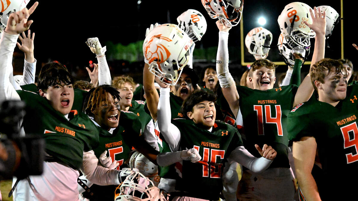 Members of the East Lincoln Mustangs celebrate their 14-7 win over South Point in the NCHSAA 3A state semifinal game on Friday, December 2, 2022 at East Lincoln High School.