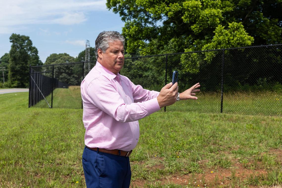 Mooresville Mayor Chris Carney checks the sound decibel levels along the perimeter of the Apple data center in Newton on June 10. 