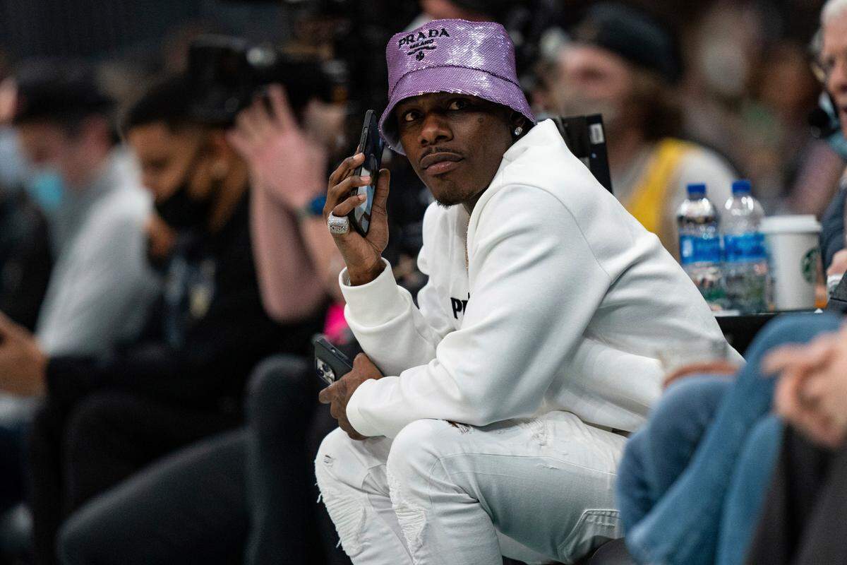 Rapper DaBaby looks on during the second half of an NBA game between the Charlotte Hornets and the Los Angeles Lakers in Charlotte, N.C., Friday, Jan. 28, 2022.