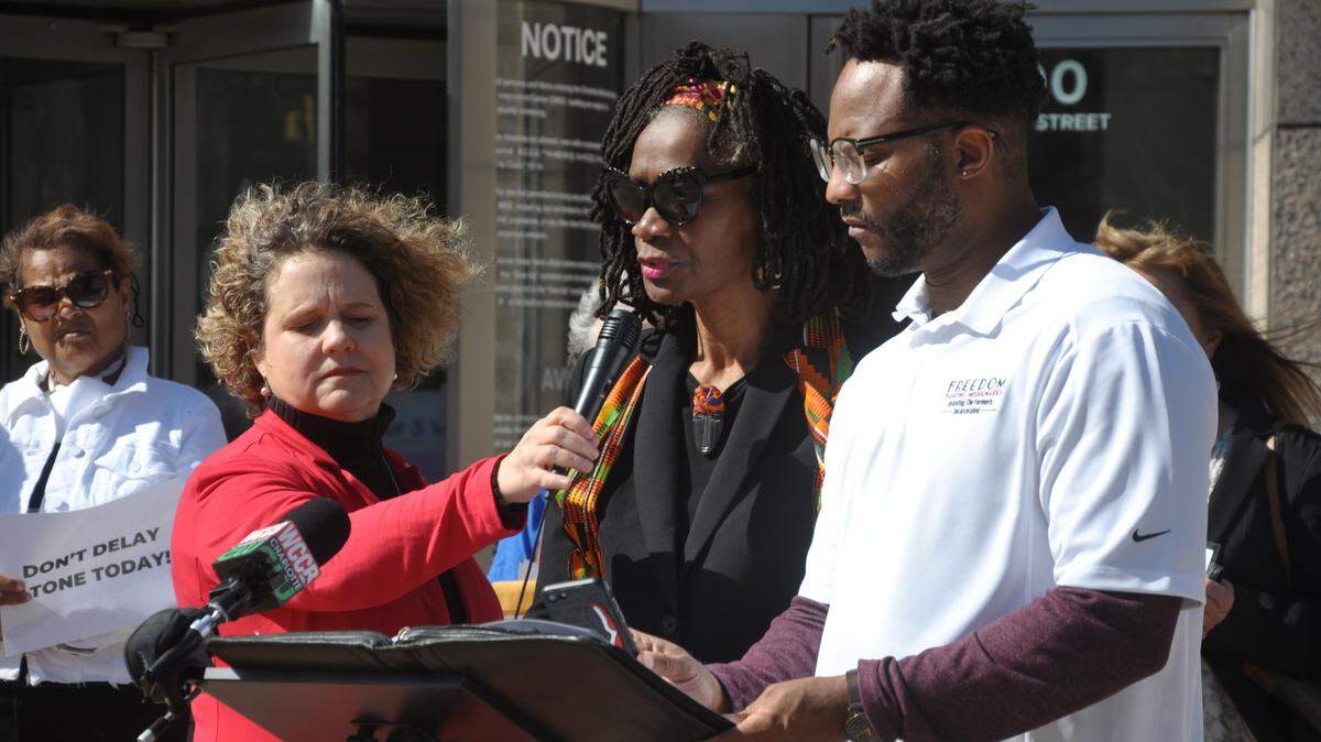 Rev. Janet Garner-Mullins, center, with former Mecklenburg Commissioner Susan Harden (left), and Kenny Robinson (right), of the Coalition for Truth and Reconciliation.