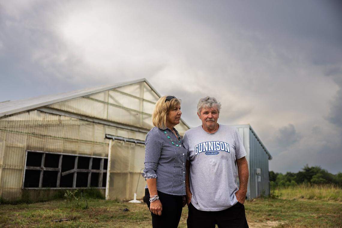 Paula Boles, left, and her husband Dale stand outside one of their former chicken barns in Caldwell County. “I’ve made mistakes before, but (deciding to become a contract chicken farmer) is the biggest one I’ve ever made,” Dale said.