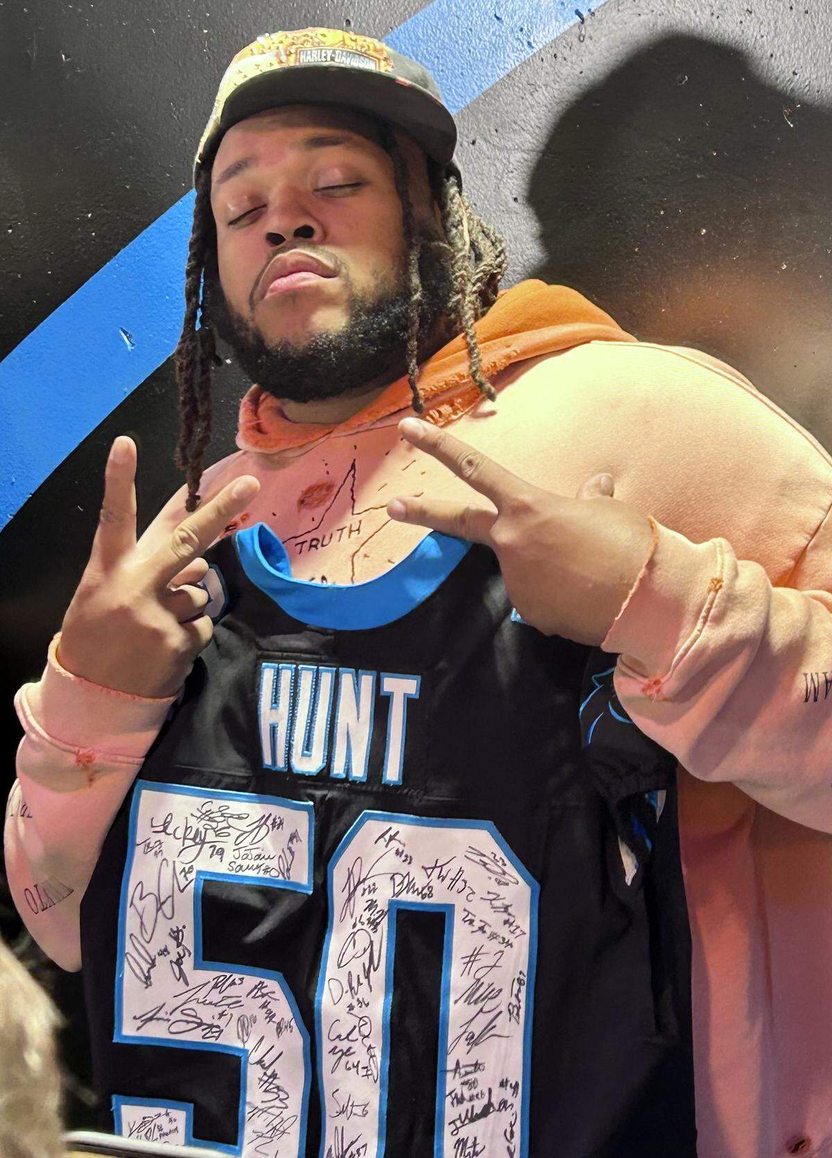 Robert Hunt shows off a jersey he was getting signed by all of his 2025 Carolina Panthers teammates on Sunday, Jan. 11, 2026, the day after Carolina’s season concluded with a 34-31 NFL playoff loss to the L.A. Rams.