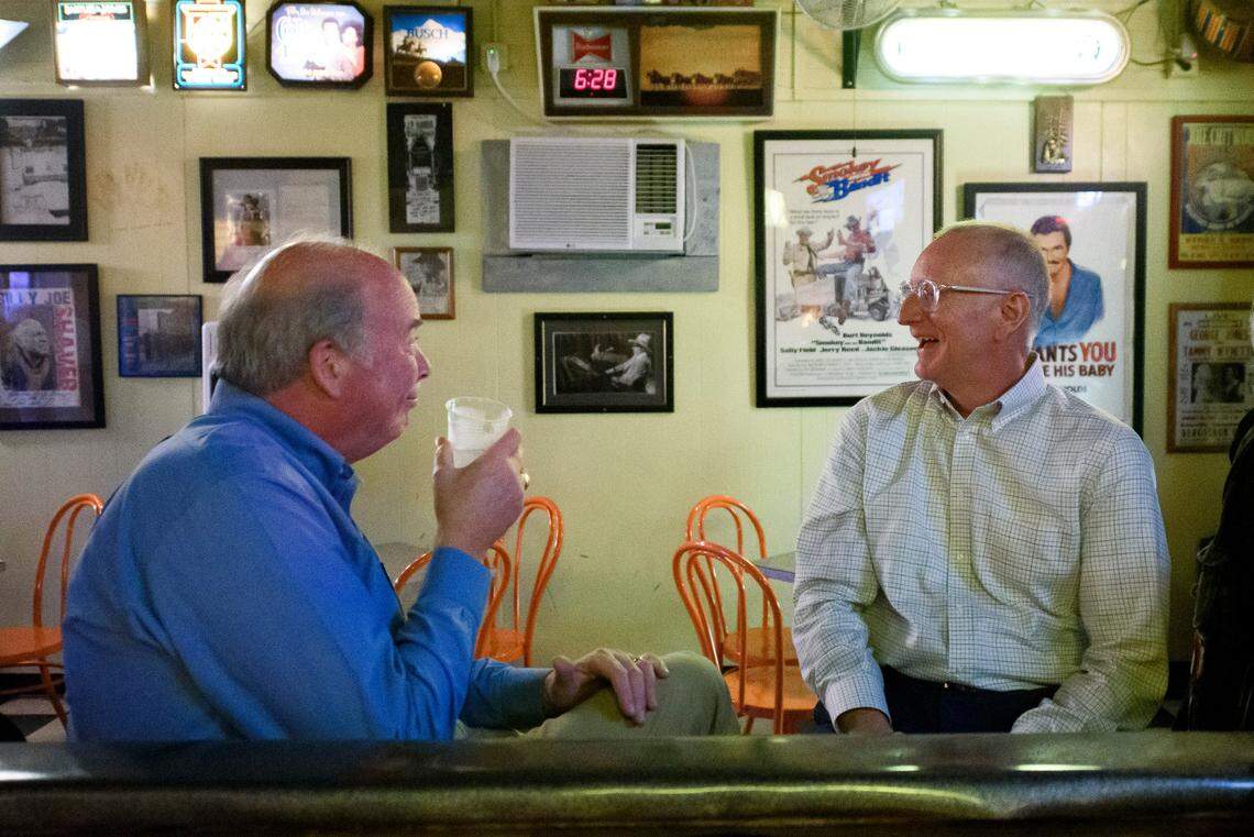 Greg Burke, left, and Scott Gerlach, both of Charlotte, talk and joke while sitting at the bar at the Thirsty Beaver Saloon.