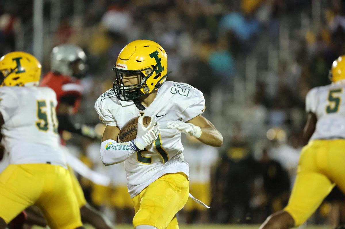 Independence sophomore Jayden Jones (21) runs the ball against the Butler Bulldogs during the Southwestern 4A title game at Butler High School on October 27, 2023.