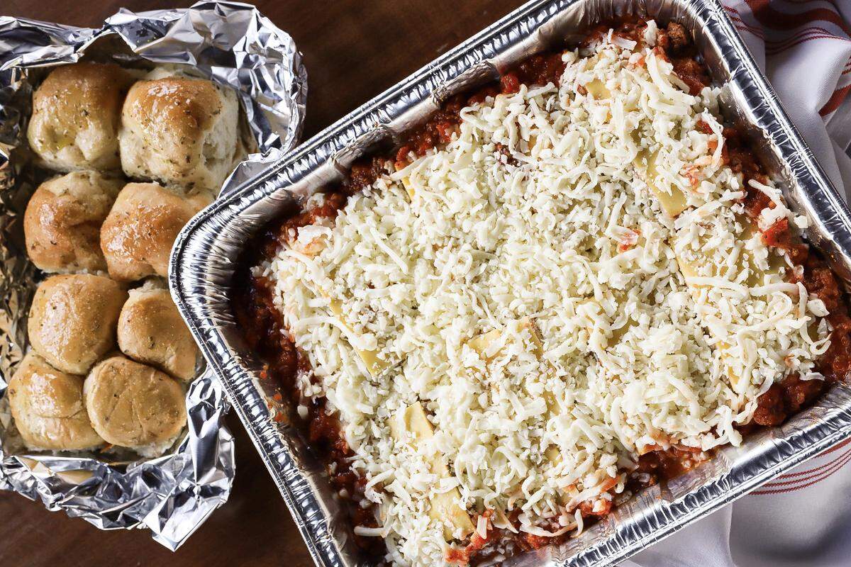 Mama Ricotta’s Southern Italian Lasagna comes with a dozen rolls. It feeds 6-8 people. Just throw it in the oven until bubbly and hot throughout.