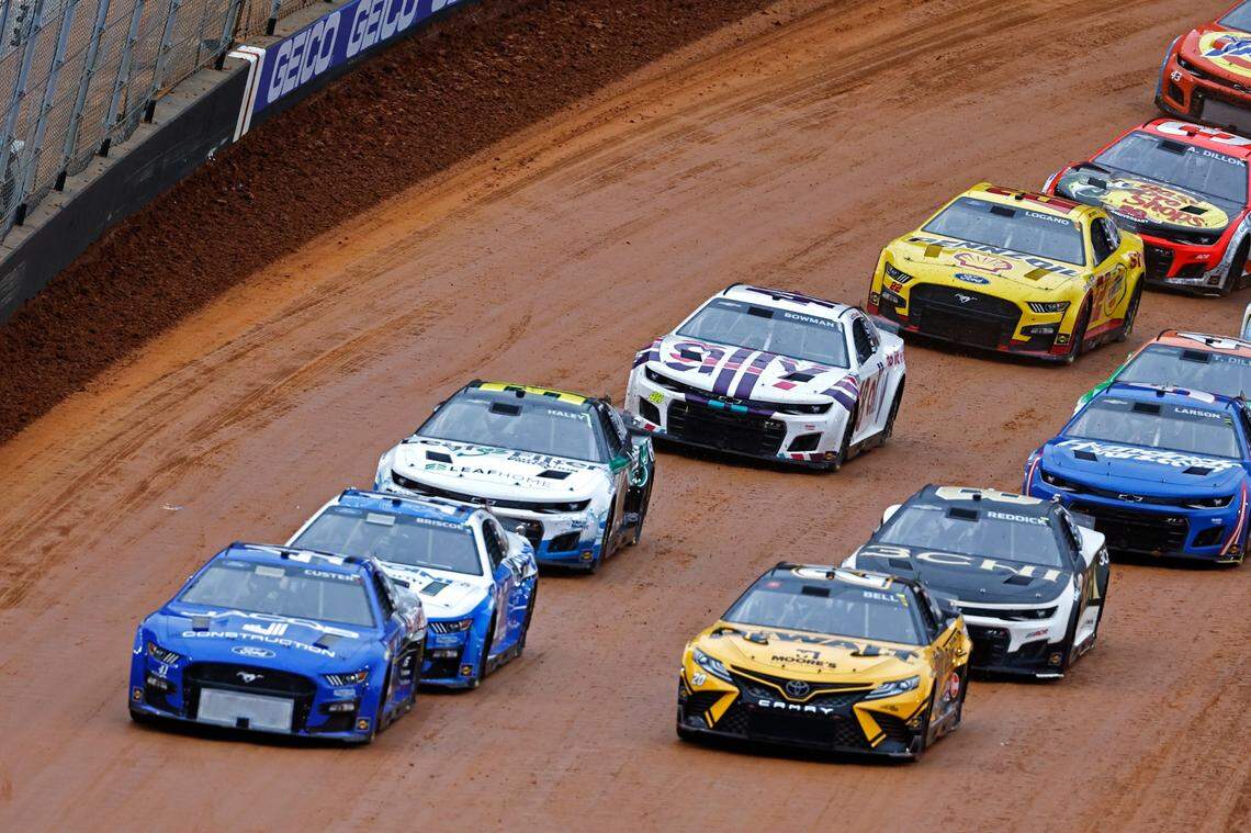 Driver Cole Custer (41) and driver Christopher Bell (20) lead the field to the start line during a NASCAR Cup Series auto race, Sunday, April 17, 2022, in Bristol, Tenn. (AP Photo/Wade Payne)