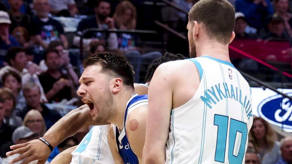 Mar 24, 2023; Dallas, Texas, USA; Dallas Mavericks guard Luka Doncic (77) looks to score as Charlotte Hornets small forward Svi Mykhailiuk (10) defends during the first quarter at American Airlines Center. Kevin Jairaj-USA TODAY Sports