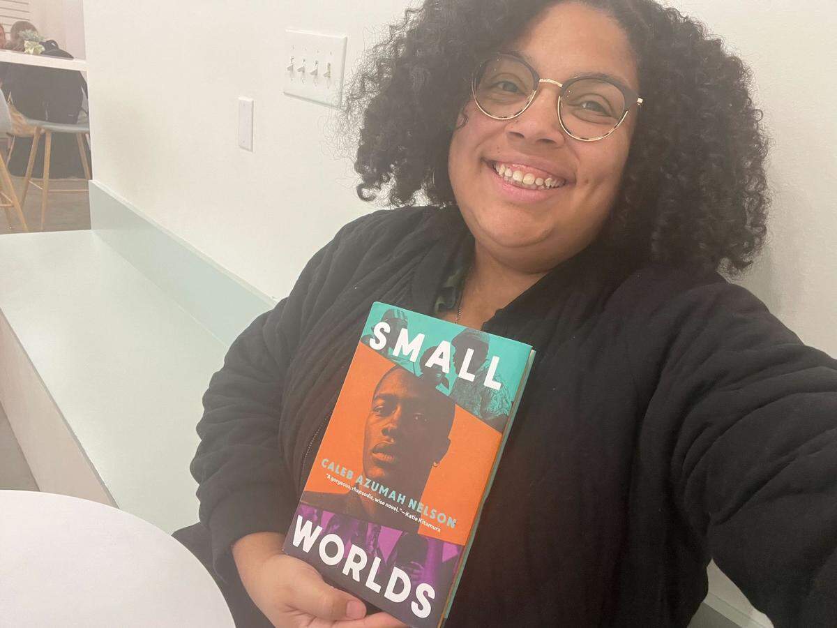 Desiree Mathurin holds a copy of “Small Worlds” by Caleb Azumah Nelson.