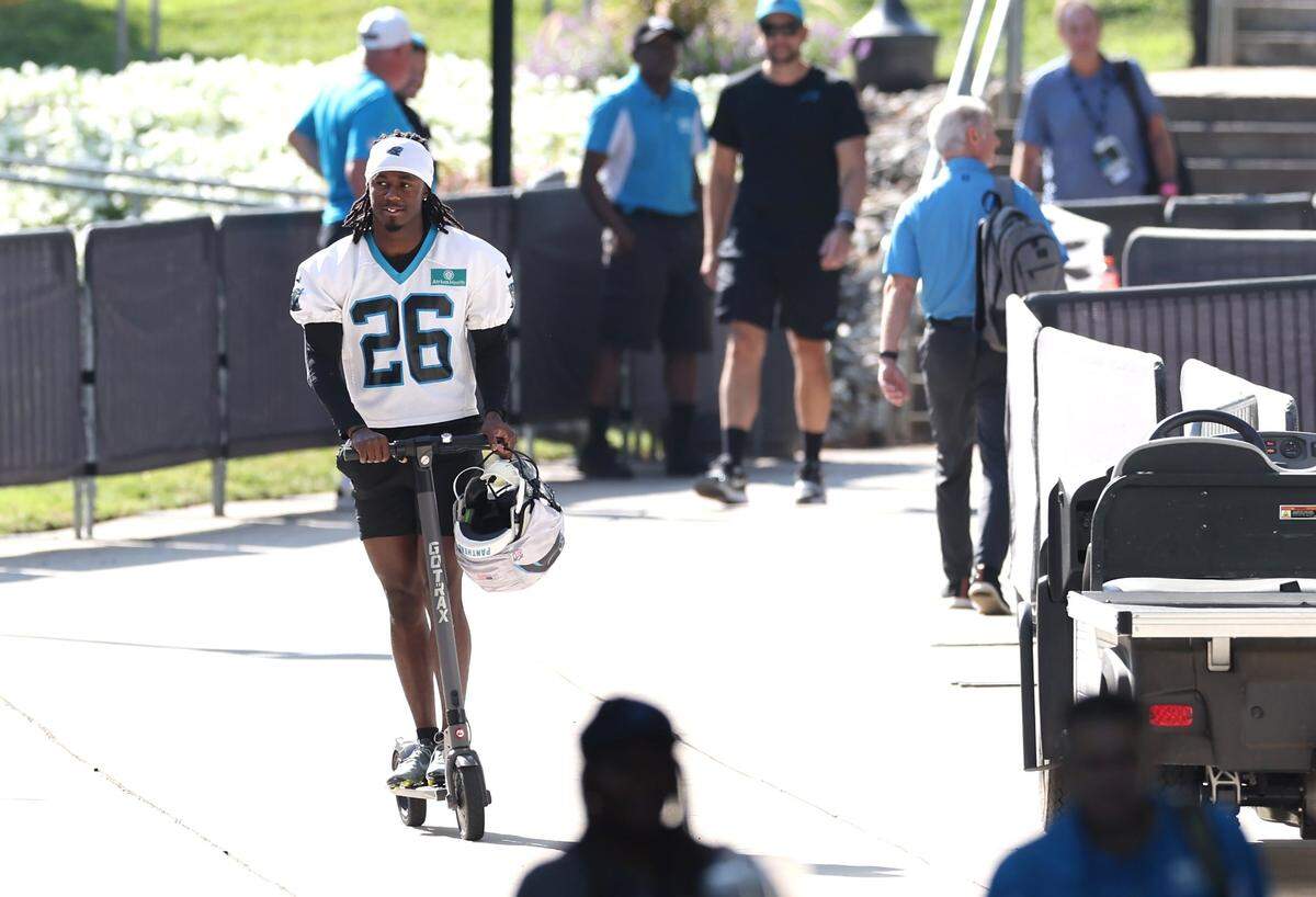 Carolina Panthers cornerback Chau Smith-Wade rides a scooter to training camp practice.