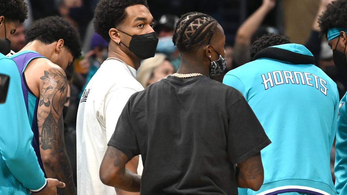 Charlotte Hornets forward PJ Washington, left, joins his teammates in a huddle during a timeout against the Boston Celtics at Spectrum Center in Charlotte, NC on Monday, October 25, 2021. The Celtics defeated the Hornets 140-129 in overtime.