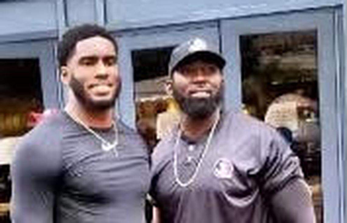Brian Burns (left) and his brother Stanley McClover both have played for the Panthers. McClover is 13 years older than Burns and trained his younger brother to be “way better than me.”