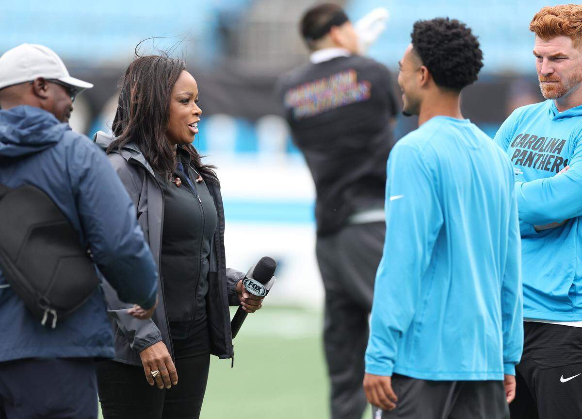 FOX Sports sideline reporter Pam Oliver, left, speaks with Carolina Panthers quarterbacks Bryce Young, center and Andy Dalton, right, prior to the team's game on Sunday, October 12, 2025. Oliver is the longest tenured NFL sideline reporter with more than 500 games.