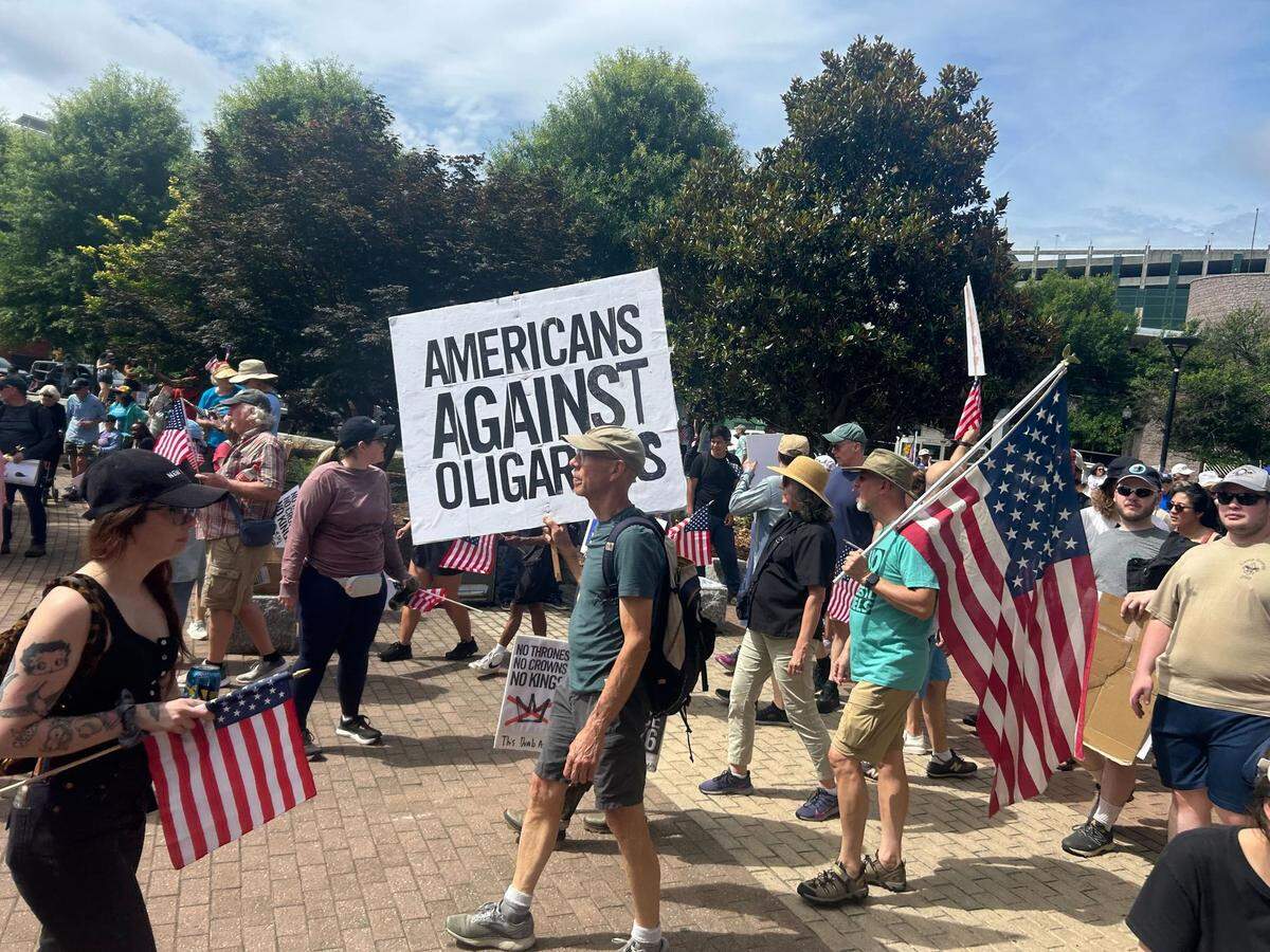 Protesters fill First Ward Park in Charlotte for a “No Kings” rally and march on Saturday, June 14, 2025.