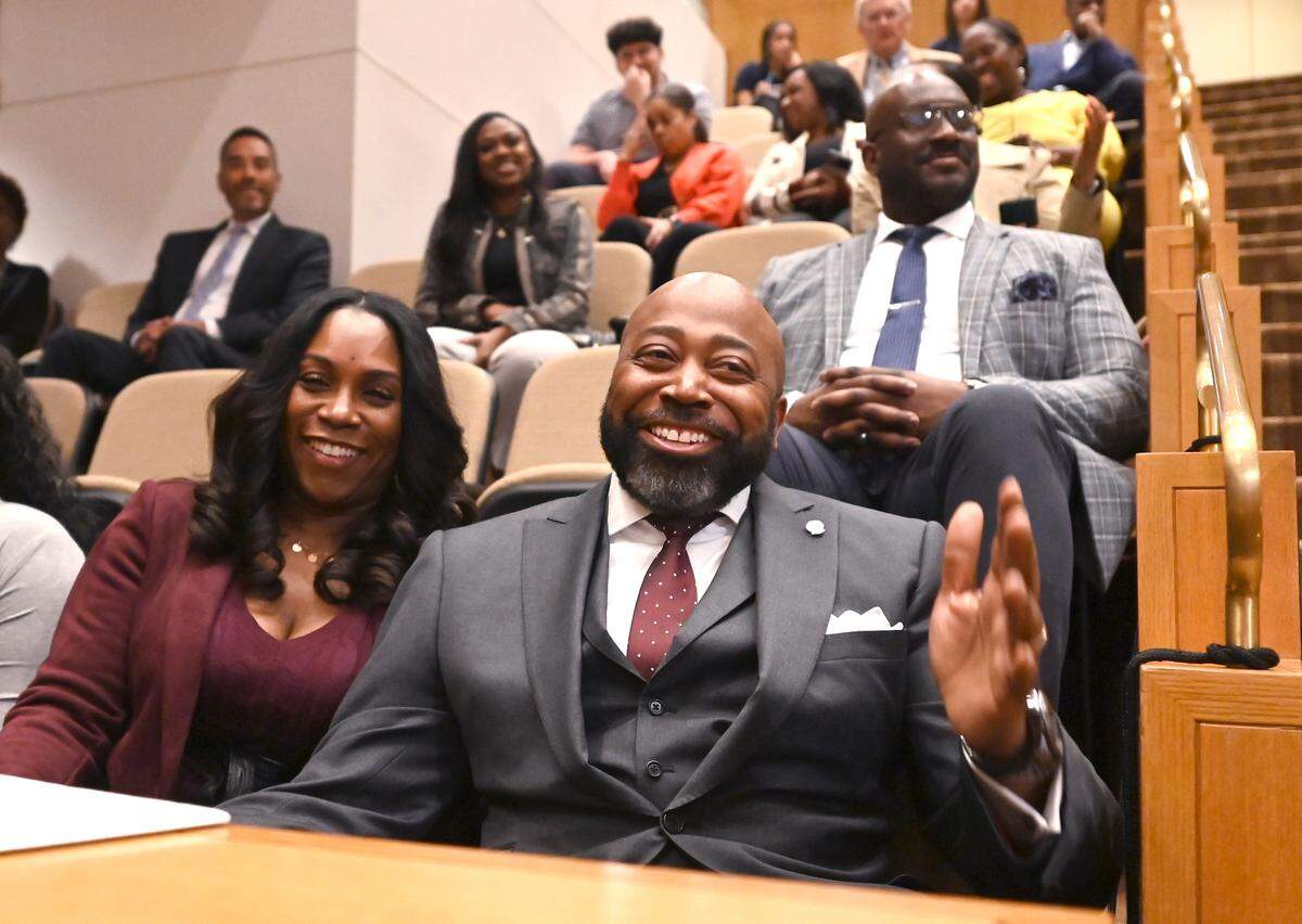 Michael Bryant, right, smiles with wife, LaShonda Bryant, left, as commissioners make remarks following Bryant being announced as the new Mecklenburg County Manager on Tuesday.